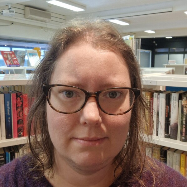 Portrett av biblioteksjef Ylva Seljenes - kvinne med briller og lilla genser som ser rett i kamera.
